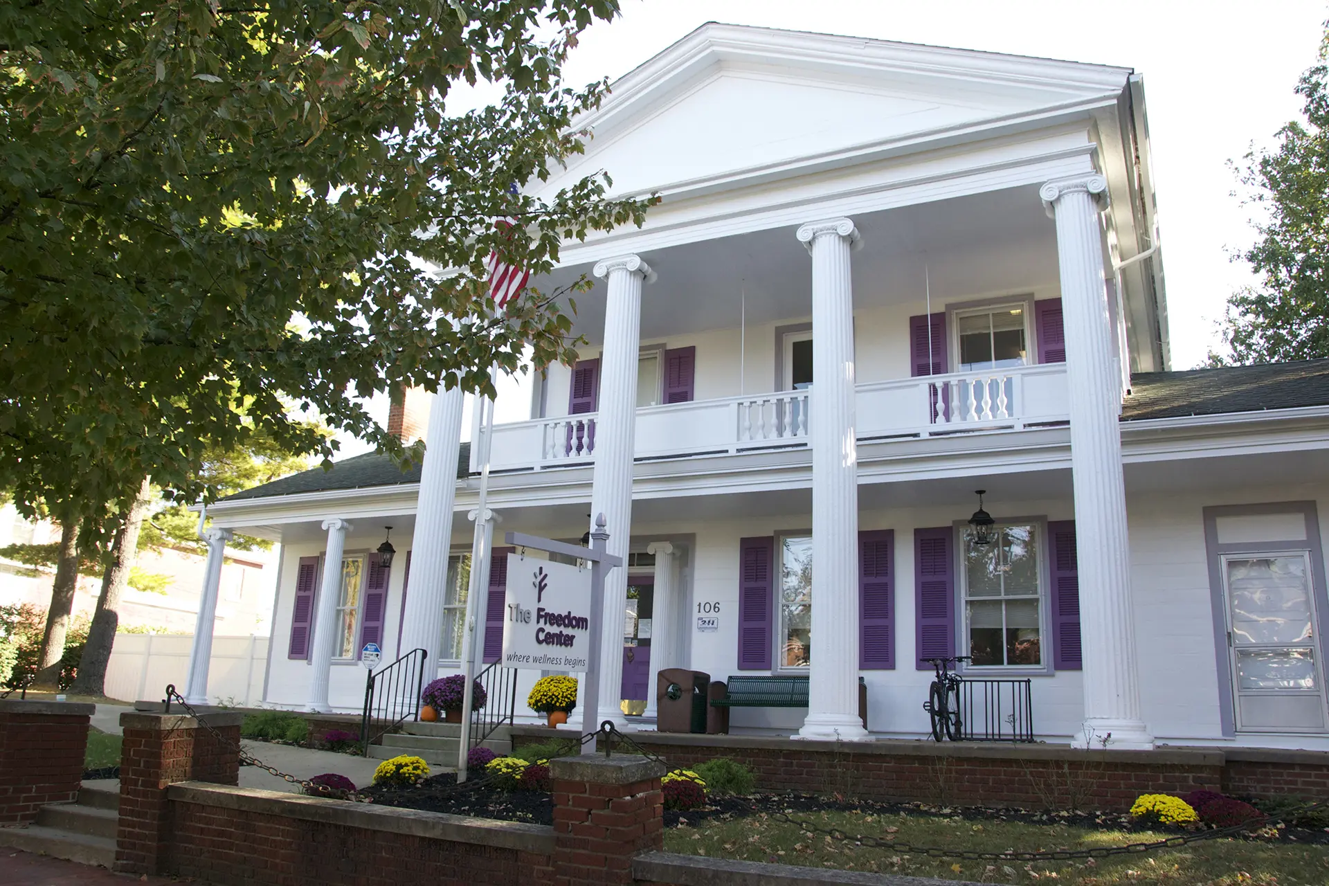Two-story white columned building with a The Freedom Center sign at the entrance