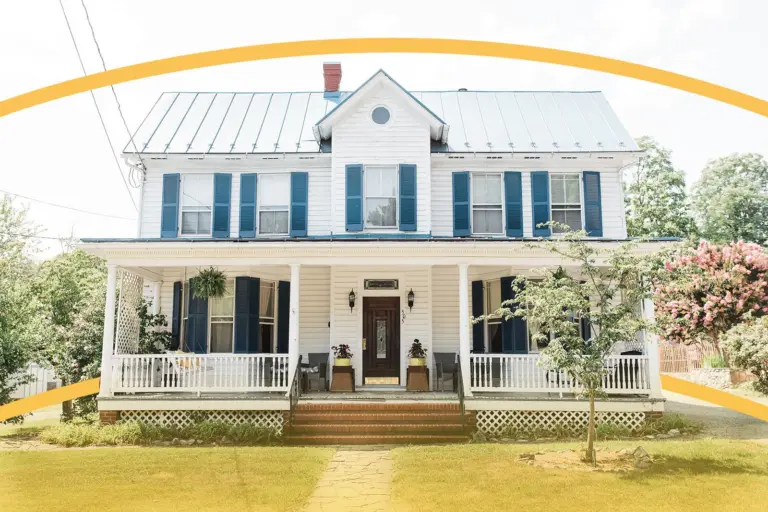 Two-story white house with blue shutters and a covered front porch