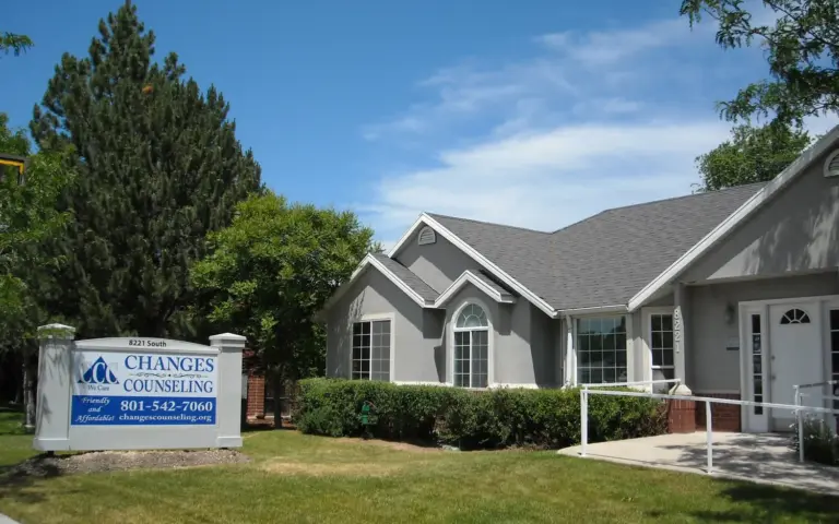 Gray one-story building with a Changes Counseling sign at 8221 South and a paved entrance ramp