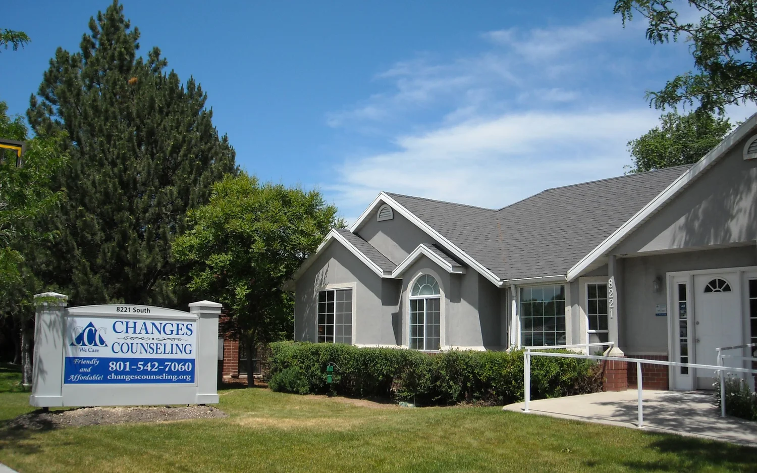 Gray one-story building with a Changes Counseling sign at 8221 South and a paved entrance ramp
