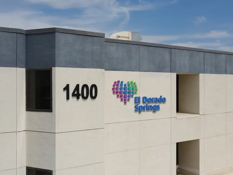 Multi-story building with a dotted heart logo and El Dorado Springs sign beside the number 1400
