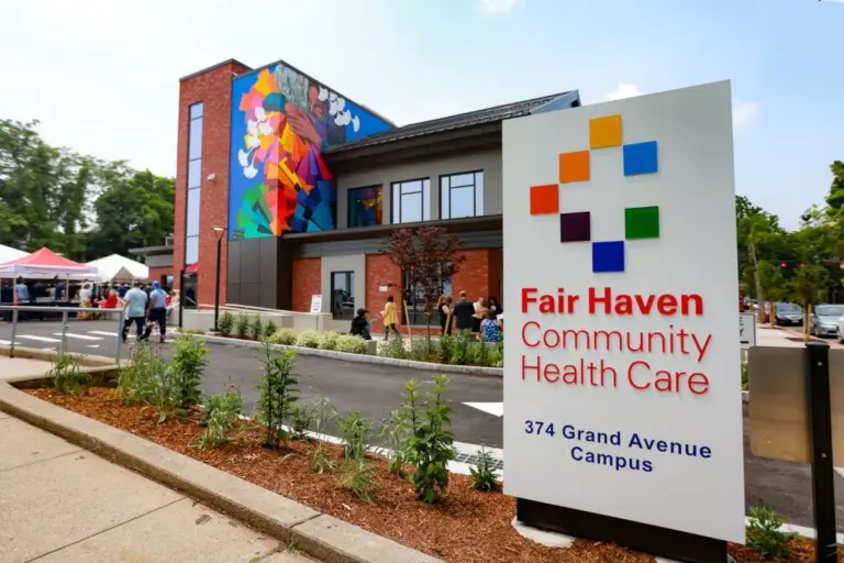 Brick and wood building at 374 Grand Avenue with a Fair Haven Community Health Care sign in front