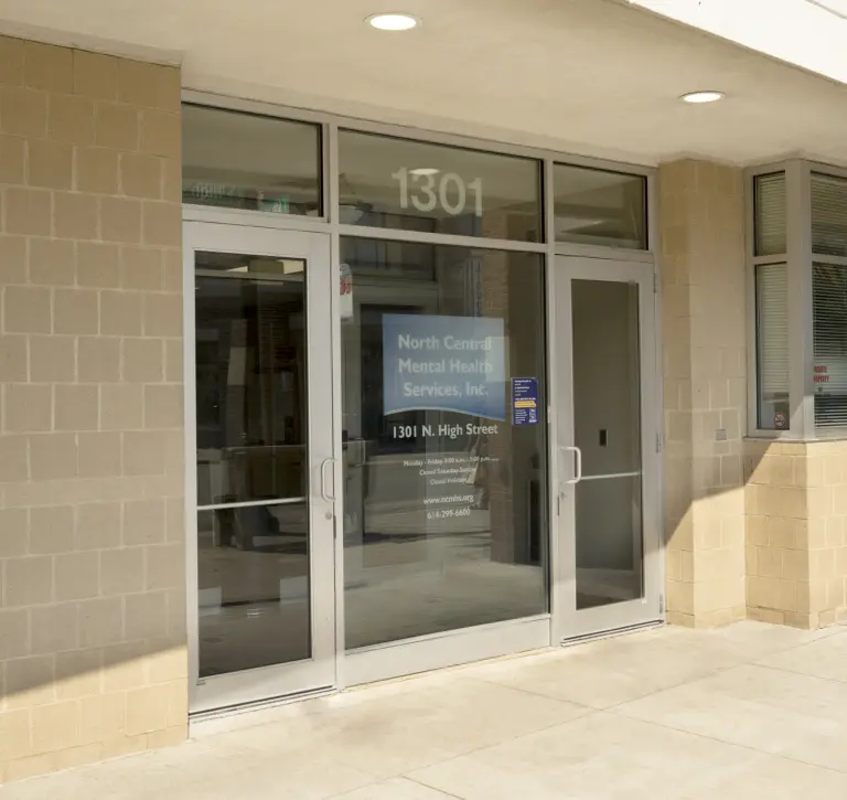Glass entrance with North Central Mental Health Services, Inc. signage at 1301 N. High Street