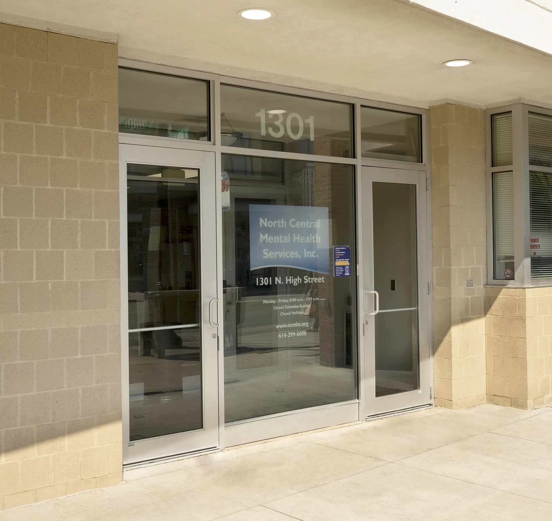 Glass entrance with North Central Mental Health Services, Inc. signage at 1301 N. High Street