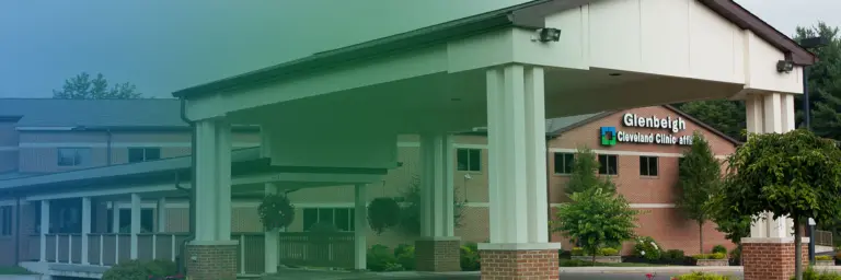 Brick Glenbeigh building with covered entrance and a Cleveland Clinic affiliate sign