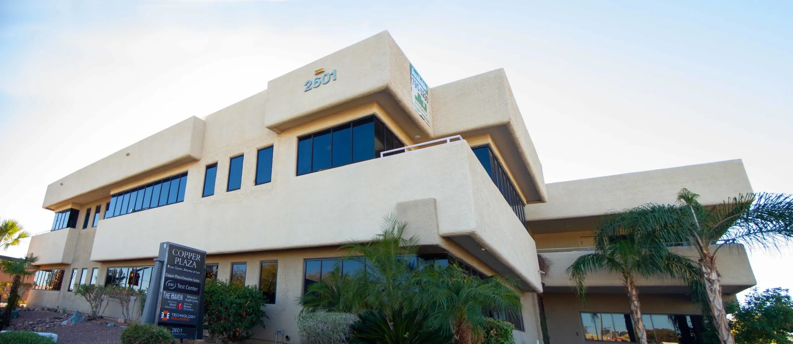 Two-story stucco office building with a Copper Plaza sign listing The Haven