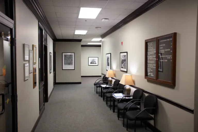 Hallway with waiting chairs and a LifeSpring Welcomes You directory board