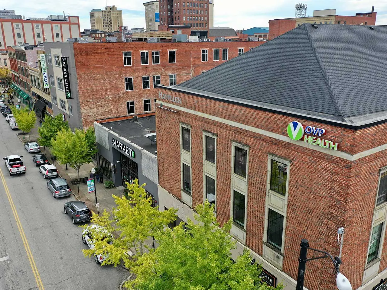 Brick building with an OVP Health sign on its facade along a city street