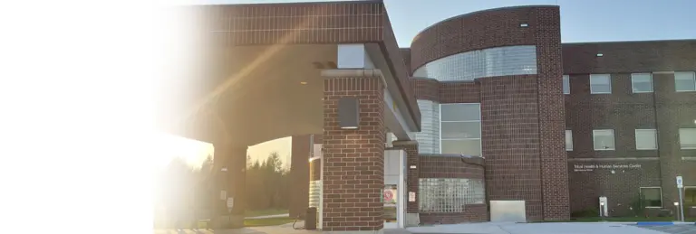 Brick building with covered entrance and a Tribal Health & Human Services Center sign