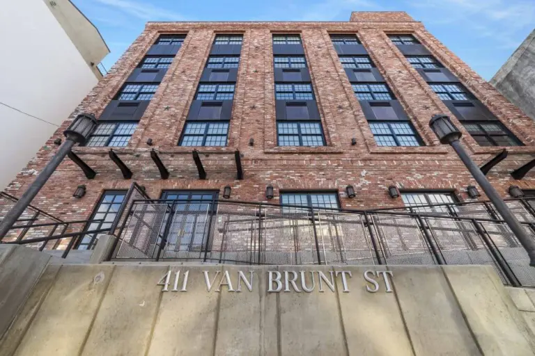 Brick building with 411 Van Brunt St address on the concrete wall