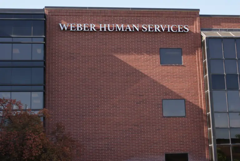 Brick building with a Weber Human Services sign above upper-floor windows