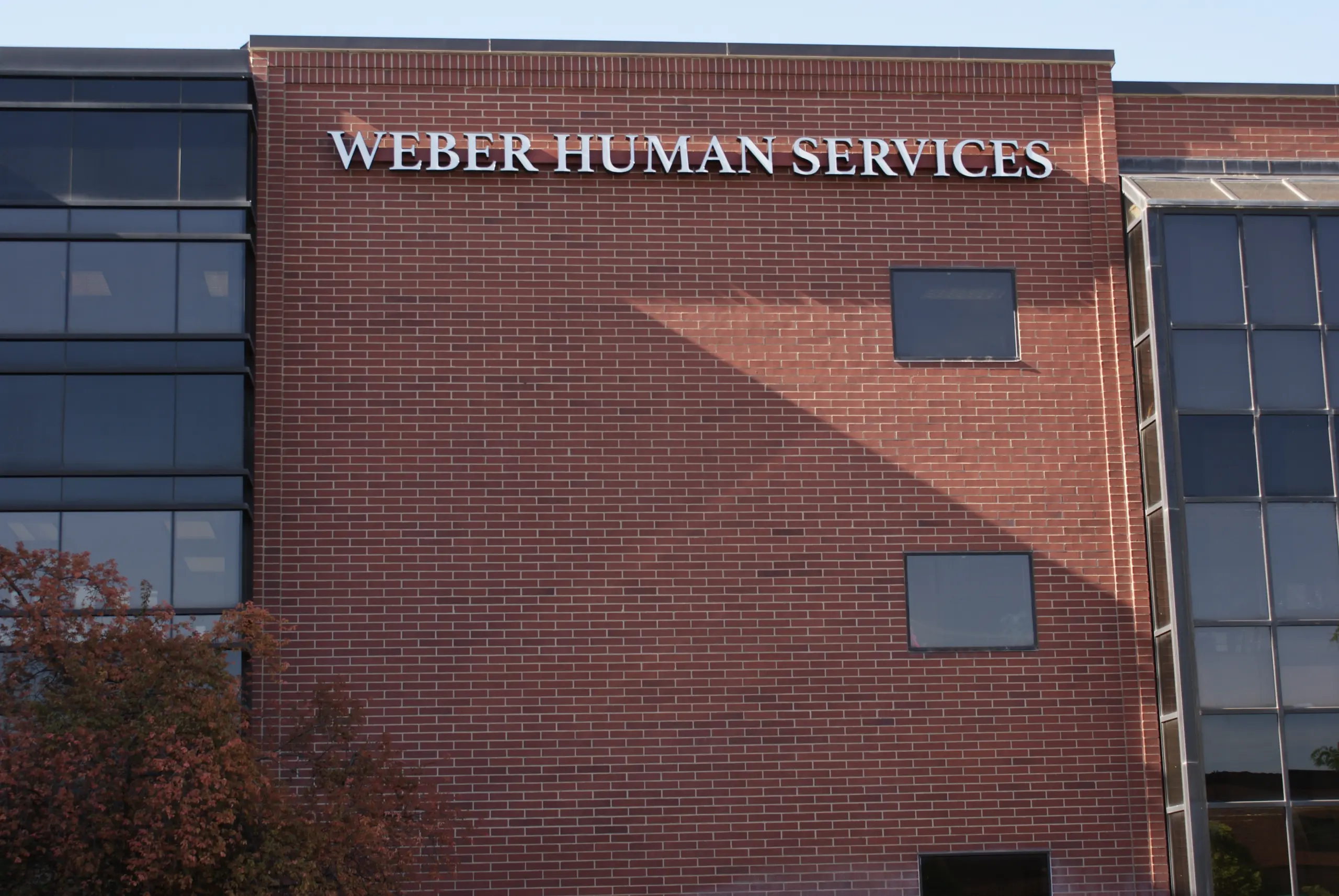 Brick building with a Weber Human Services sign above upper-floor windows